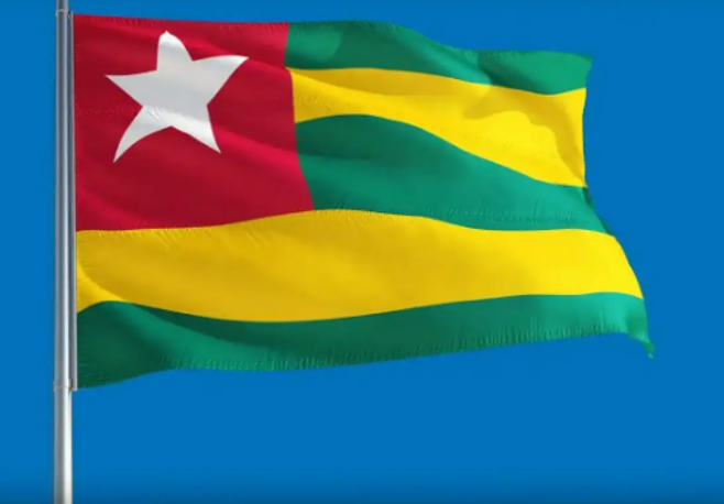 A flag of togo is waving in the wind.