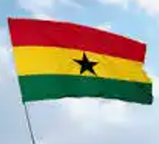 A flag of ghana is flying in the sky.