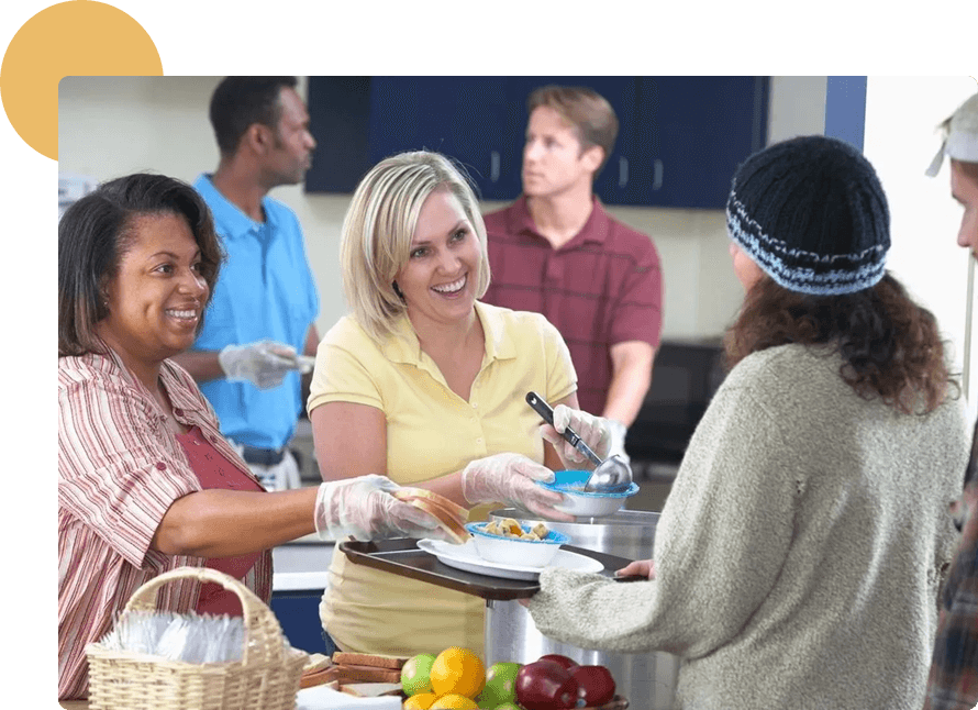 A group of people standing around a table.