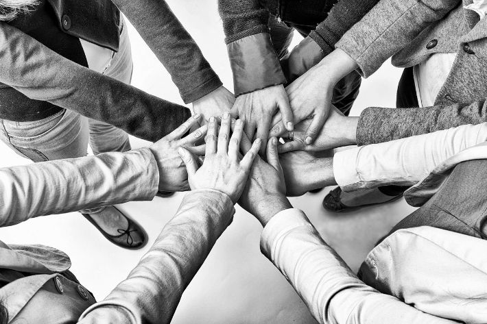 A group of people with their hands in the air.