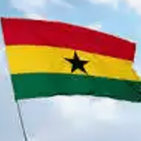 A flag of ghana is flying in the sky.